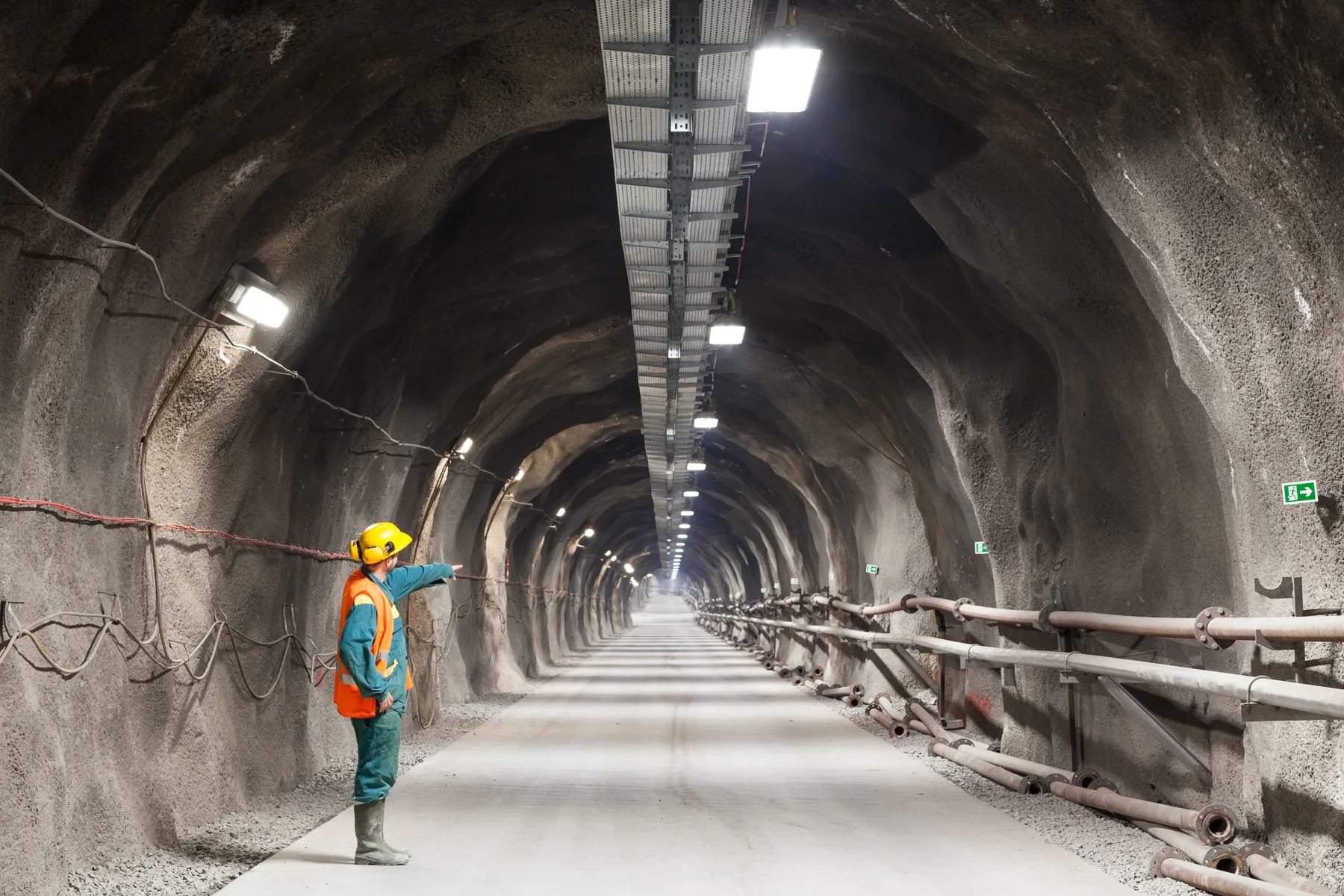 Illustrative underground tunnel with a worker inspecting the excavation
